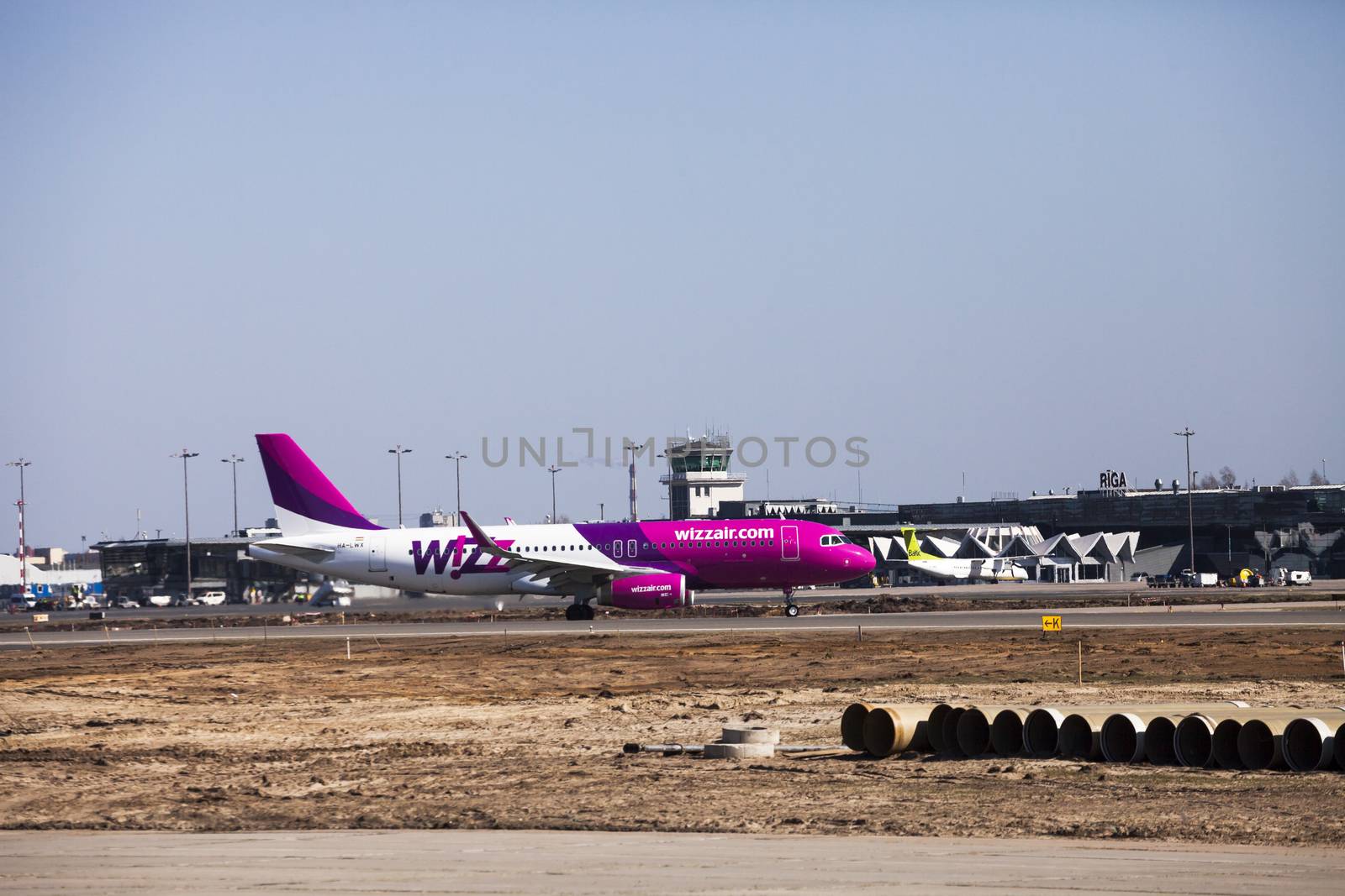 RIGA, LATVIA - APRIL 10, 2014: Wizz Air Airbus A320-232 after landing at Riga International Airport. Wizz Air is a Hungarian low-cost airline. From June 19 it will open new airbase in Riga.