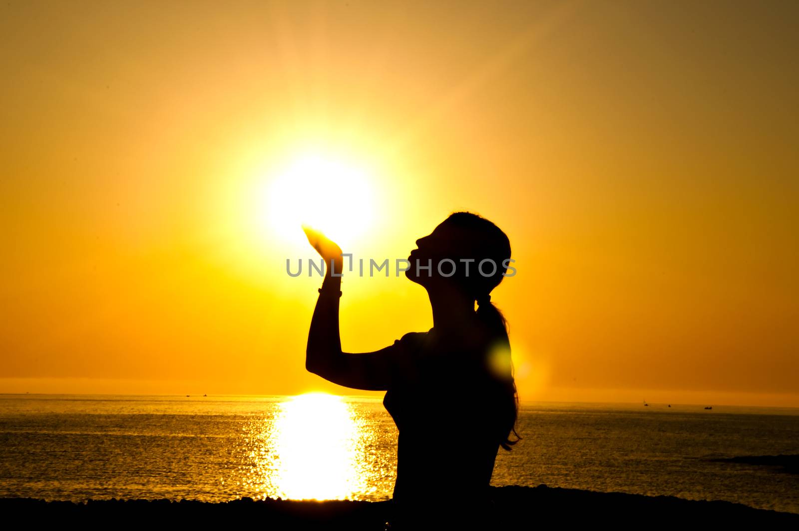 A beautiful girl silhouette kiss  the sun