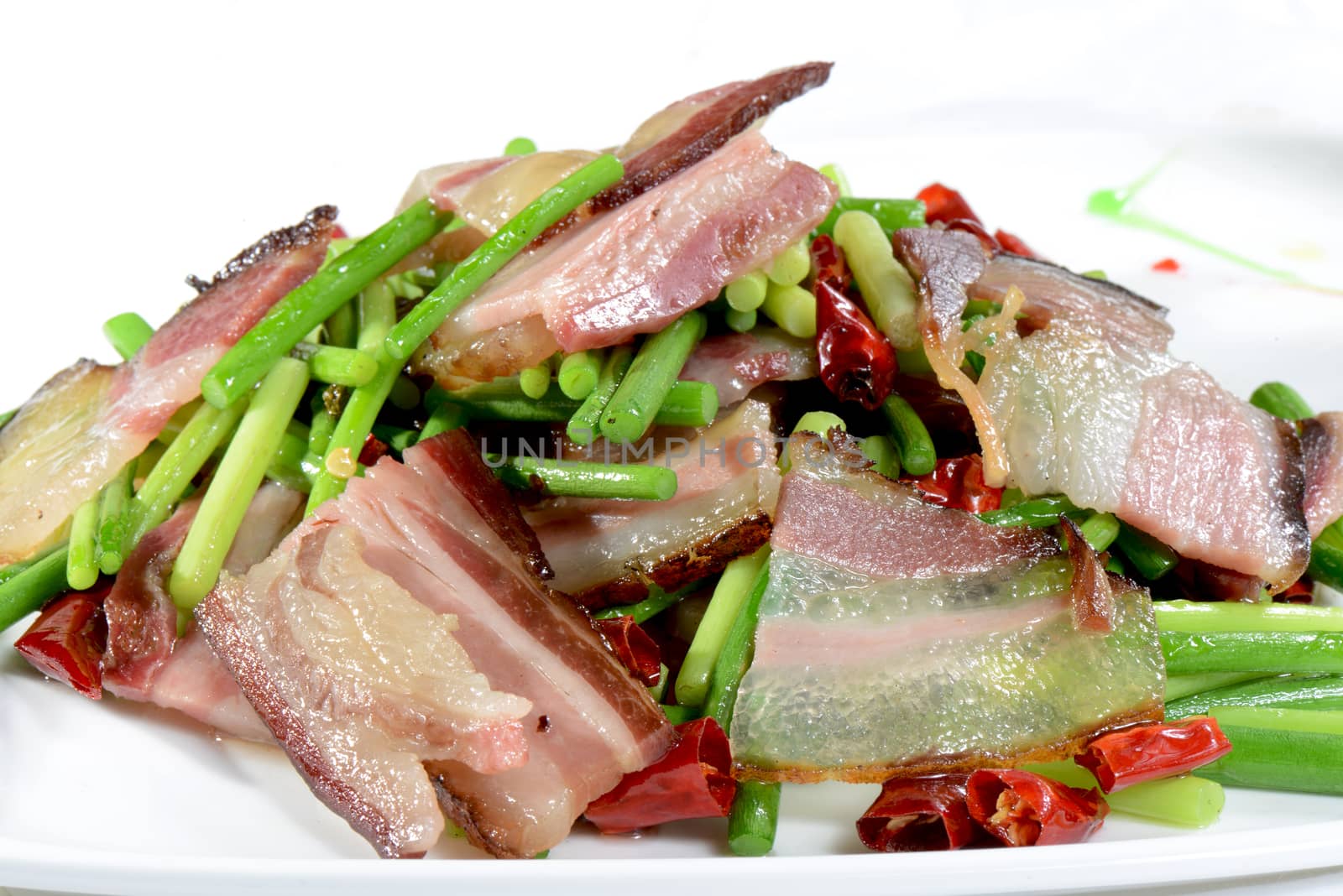 Chinese Food: Fried bacon with vegetable in a white plate