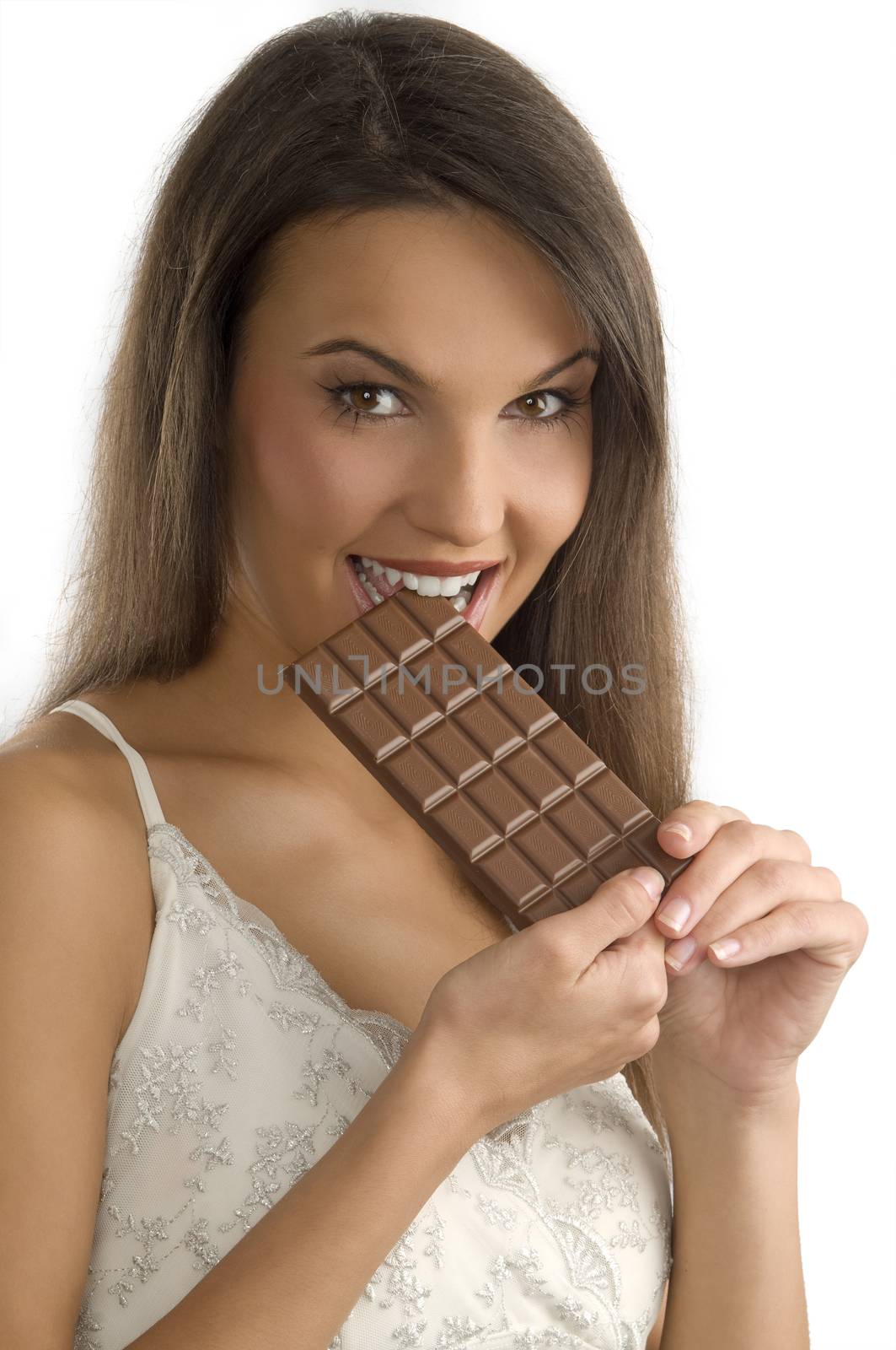 pretty young brunette biting a block of chocolate with her teeth