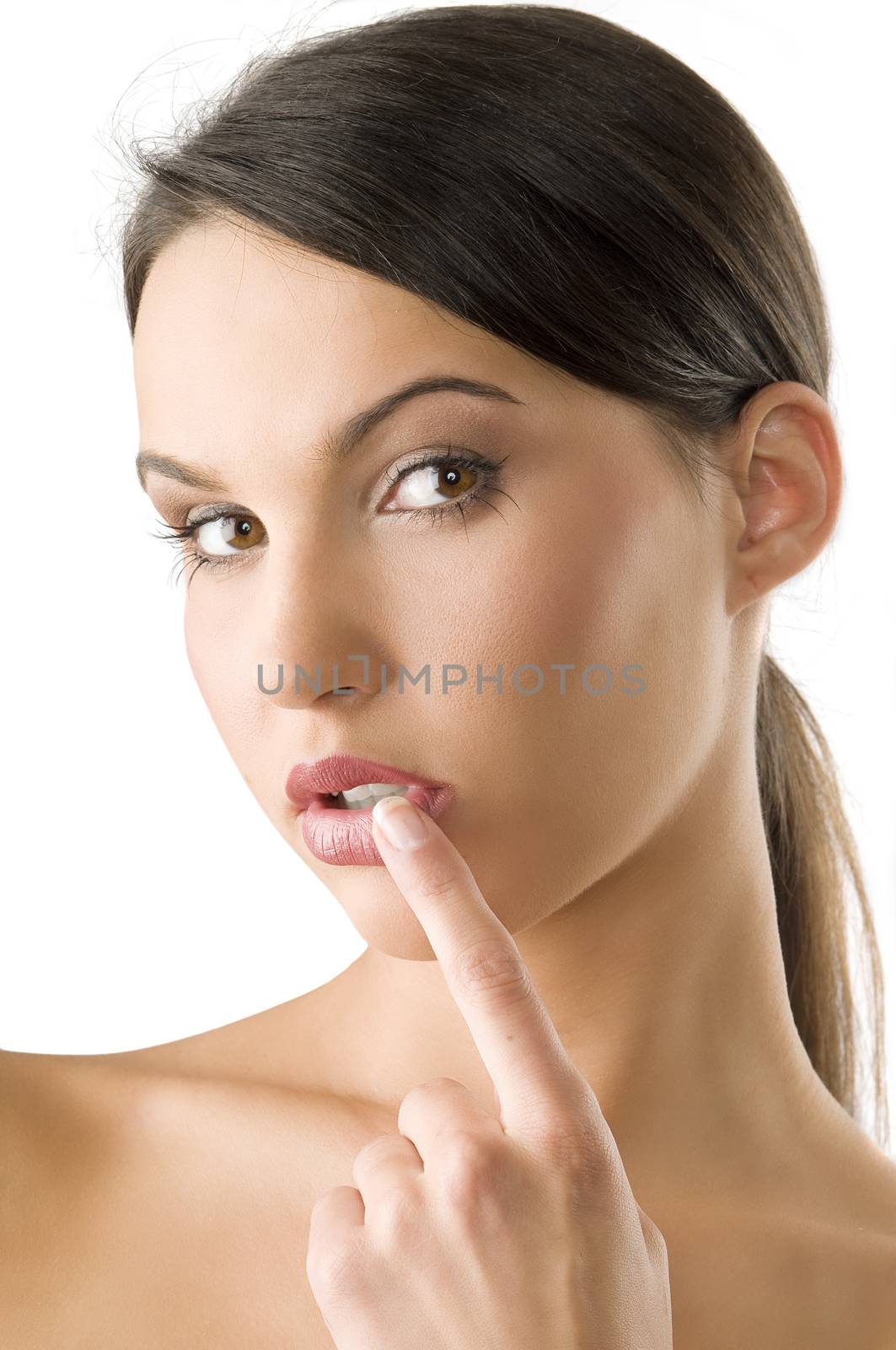 beauty portrait of a pretty girl with a finger near her mouth