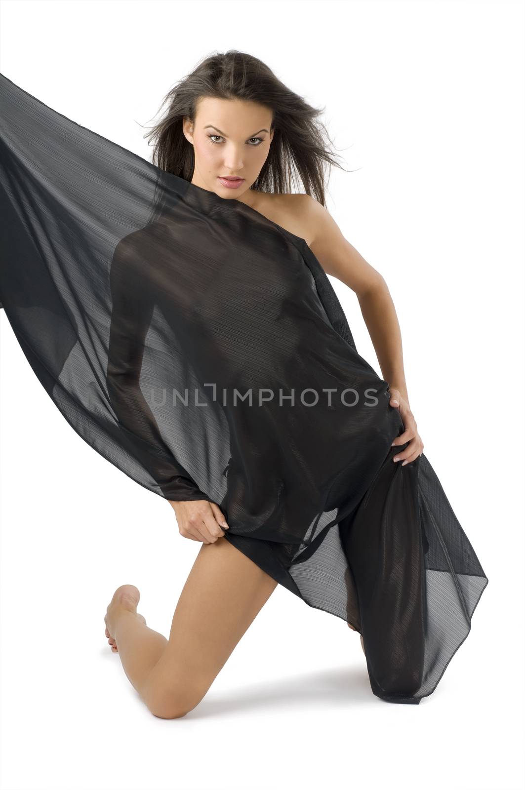 nice young woman covering her body with black fabric and wind in hair