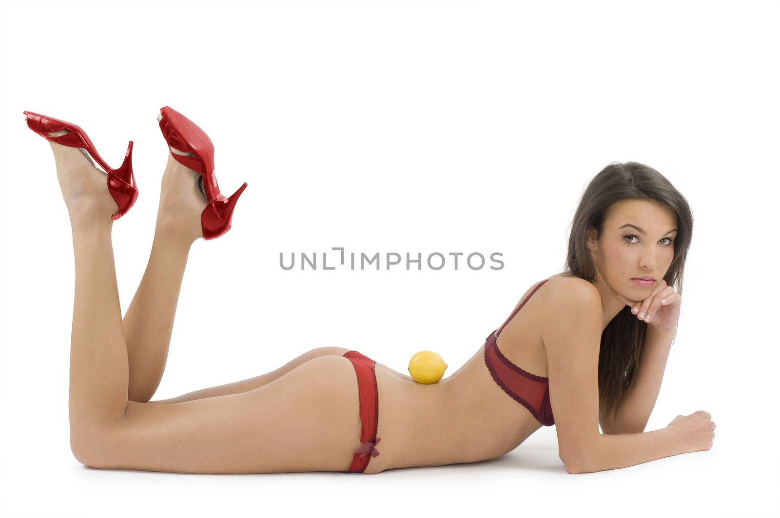 sexy brunette in red lingerie red shoes and a lemon on her back