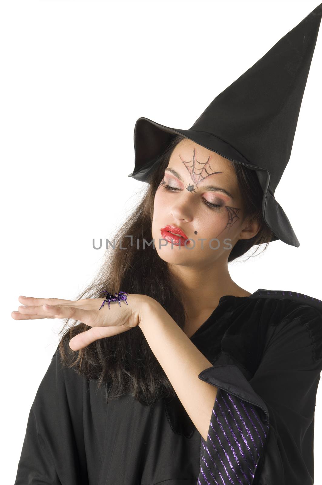 pretty girl with witch hat and a spider on her hand