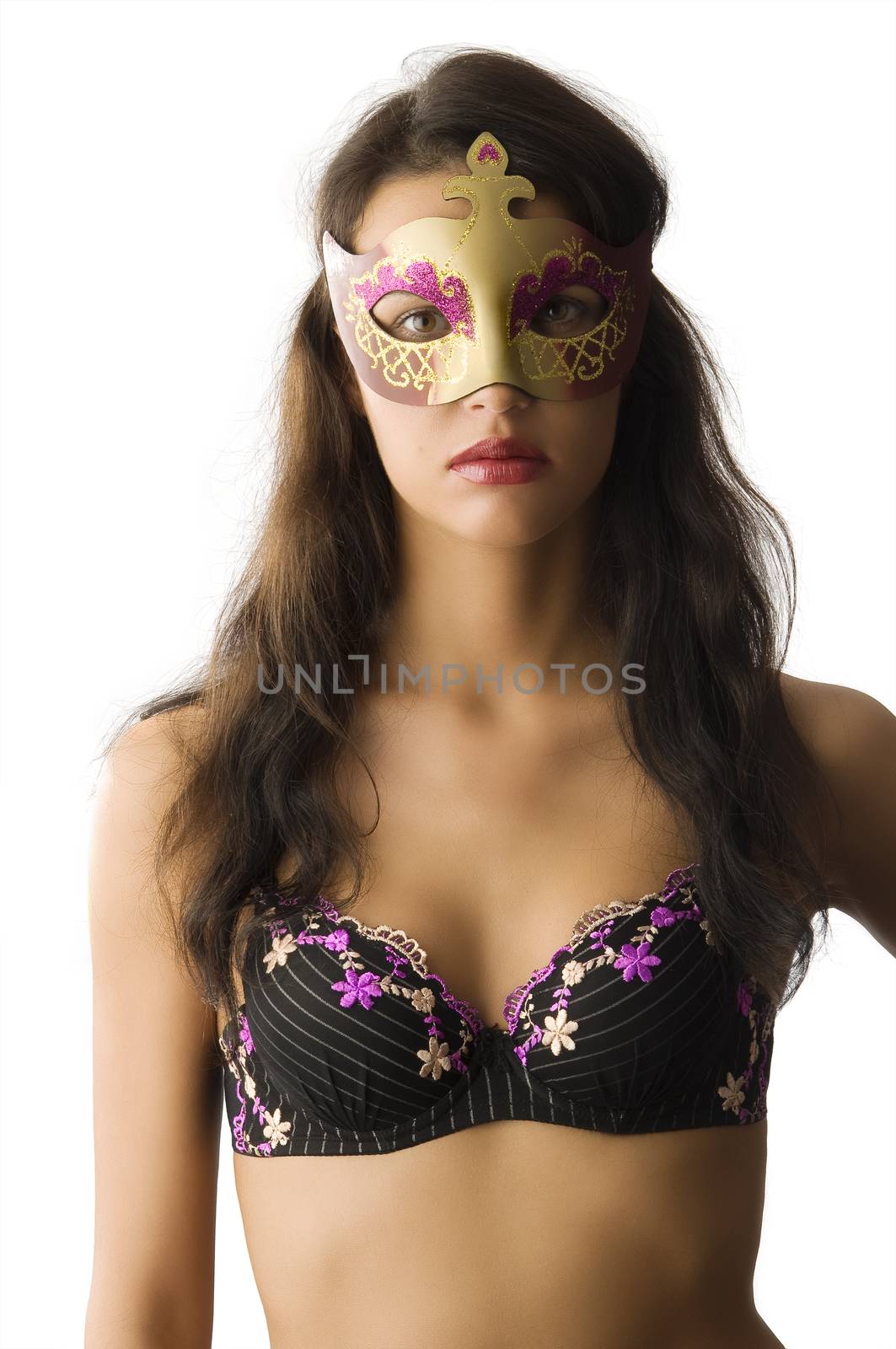 beautiful brunette wearing top lingerie and hiding face with golden mask
