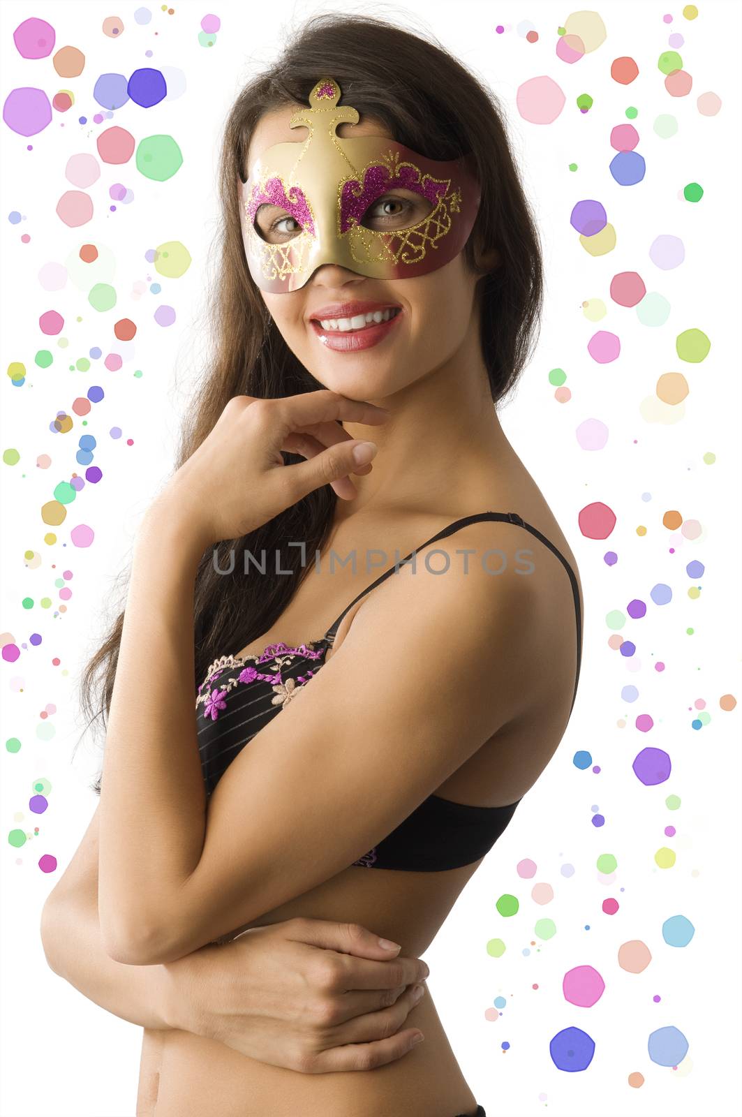 cute brunette in bikini hiding face behind a carnival mask smiling