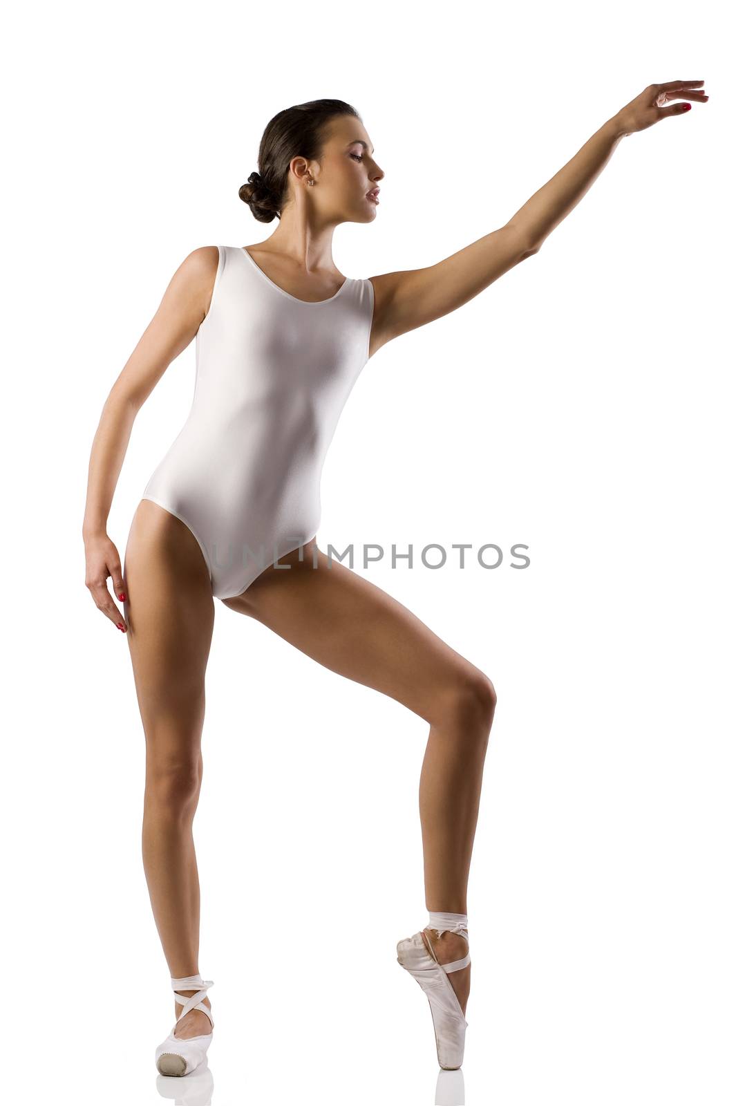 Young caucasian brunette ballerina girl performing a dance on white background and white floor