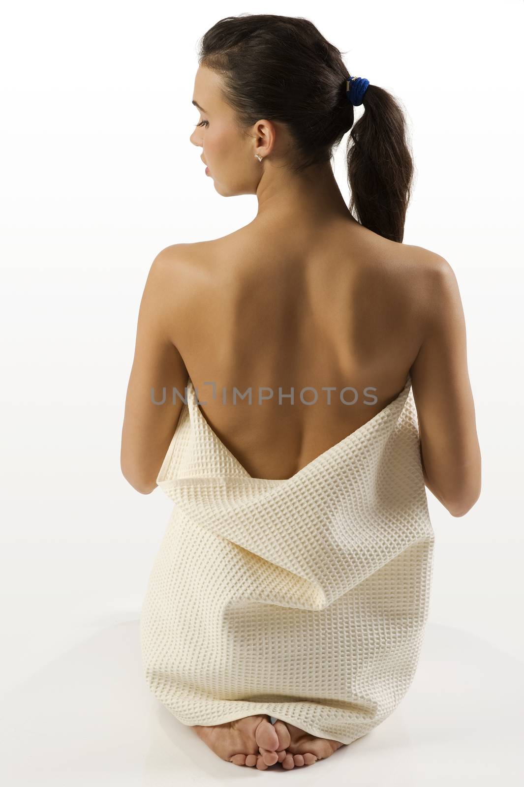 back side beauty portrait of a young cute brunette showing her nude shoulder