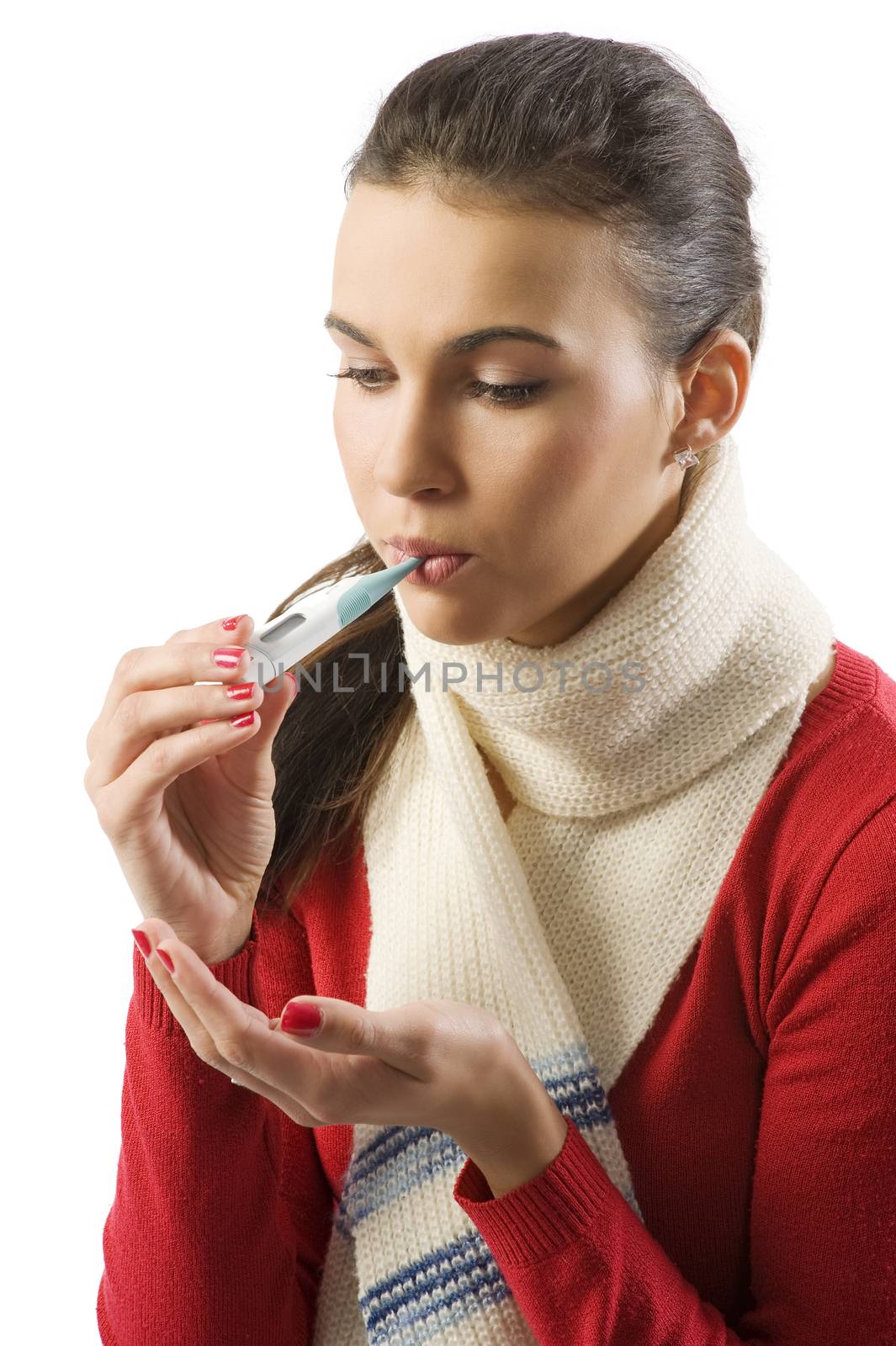 Closeup portrait of young ill woman checking her body temperature