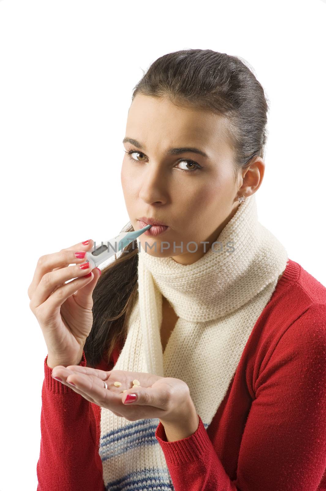 portrait of young brunette with red sweater and white scarf checking her body temperature