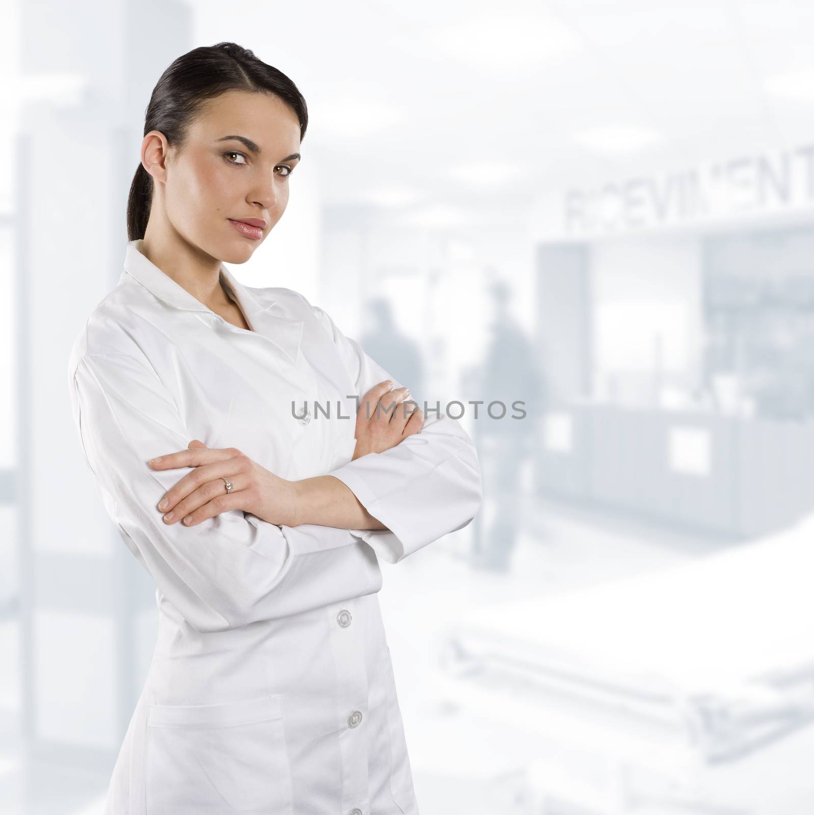 cute brunette woman in white gown as a medical doctor looking in camera