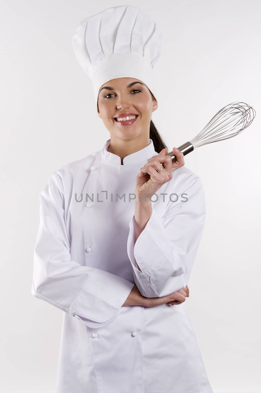 young graceful woman dressed as a cook with cap over white backgound