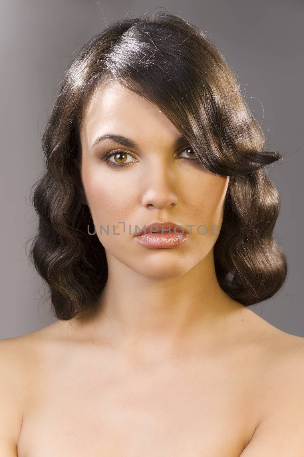 nice poertarit on dark background of beautiful brunette with an old fashion hair stylish