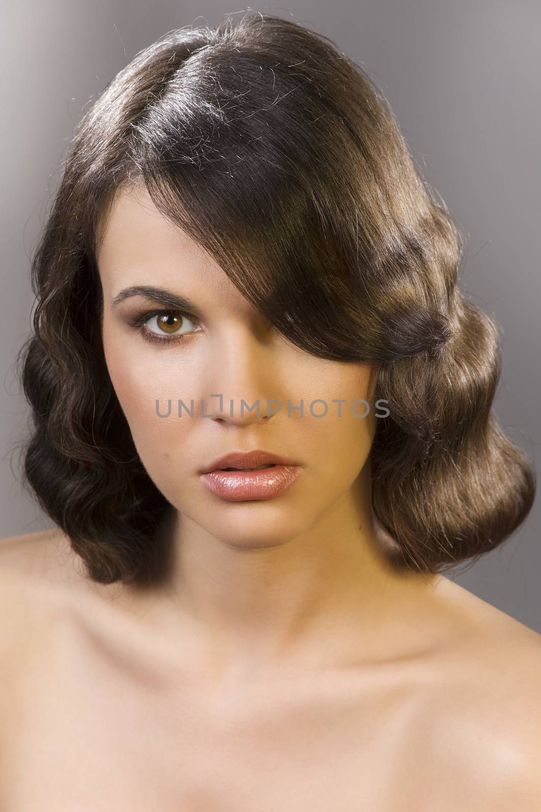 nice poertarit on dark background of beautiful brunette with an old fashion hair stylish