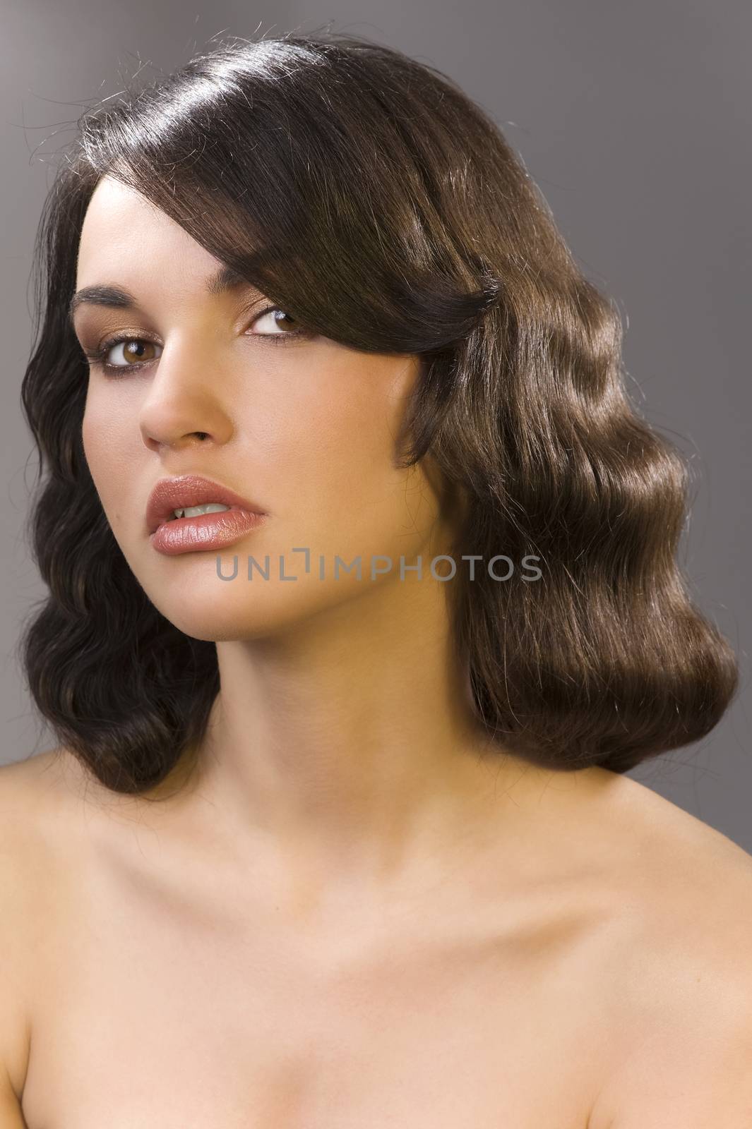 nice poertarit on dark background of beautiful brunette with an old fashion hair stylish