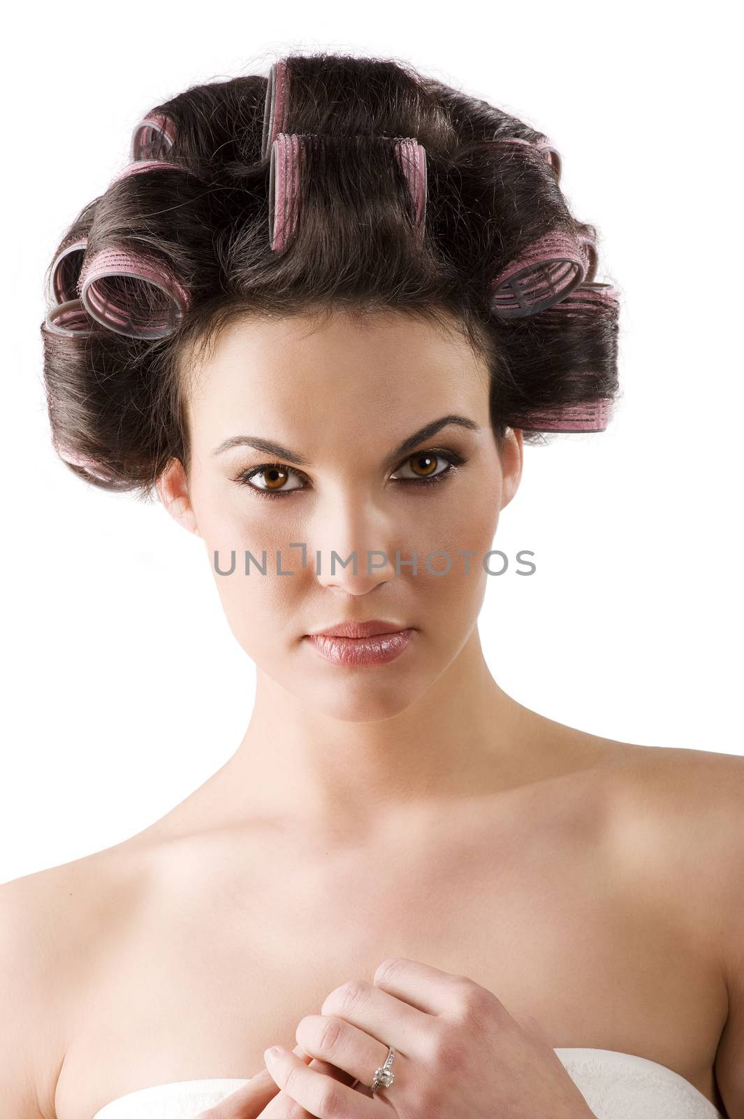 beauty portrait of a young brunette woman with hair curlers in her hair