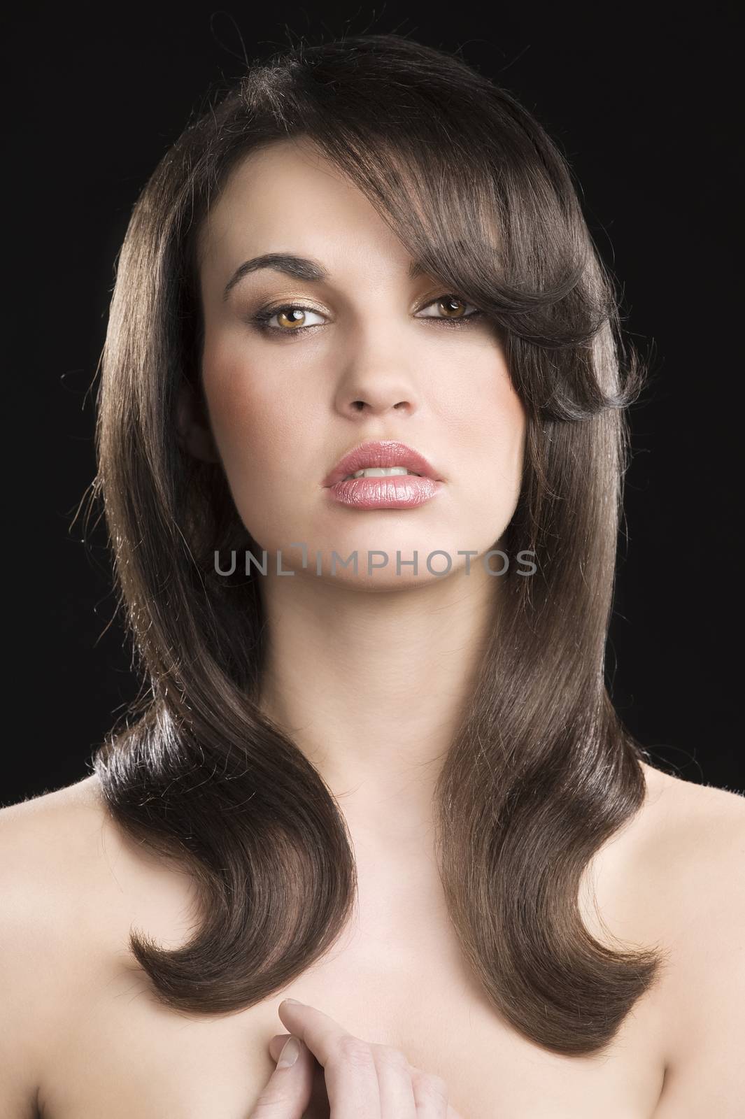Portrait of beautiful sensual woman with elegant hairstyle over black background