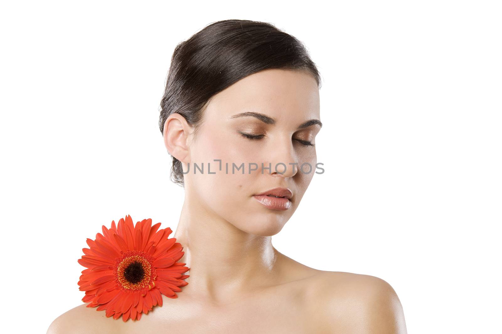 fresh portrait of a young brunette woman wiith color flower near the her face