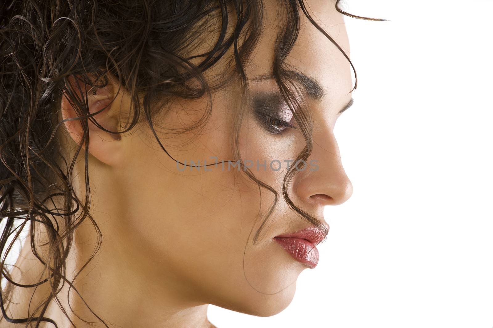 close up portrait of a beautiful brunette with wet hair and creative hair style