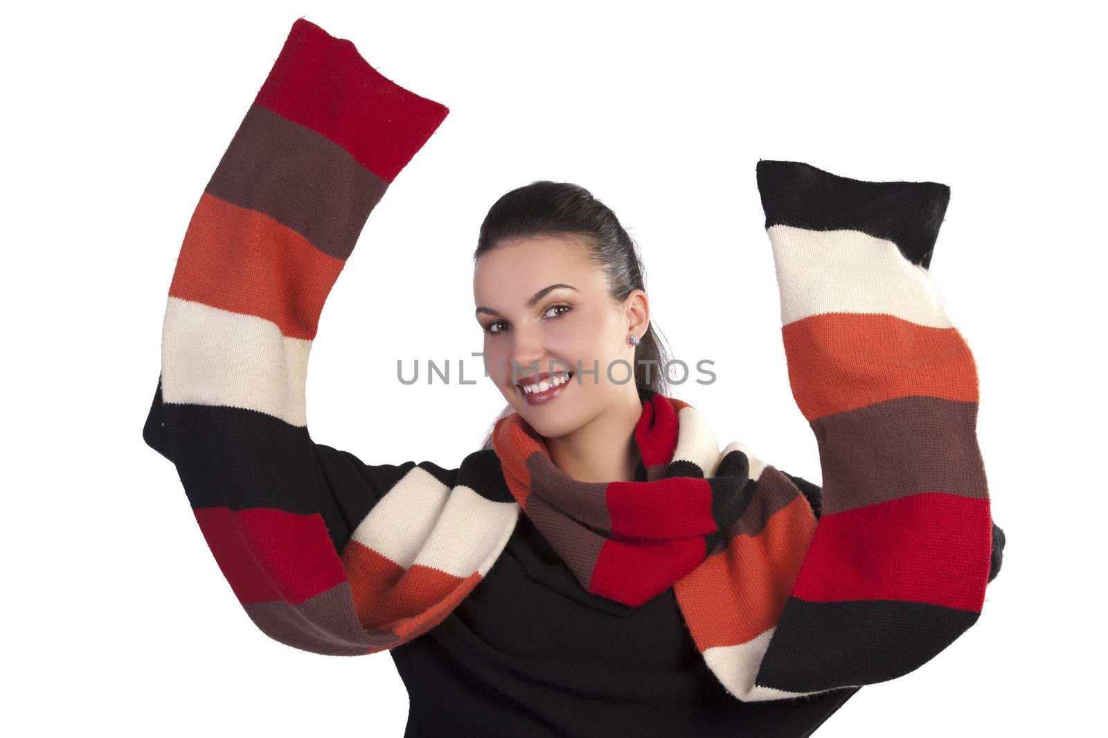 Autumn shot of a happy young pretty brunette wearing a dark sweater and a fall color long scarf