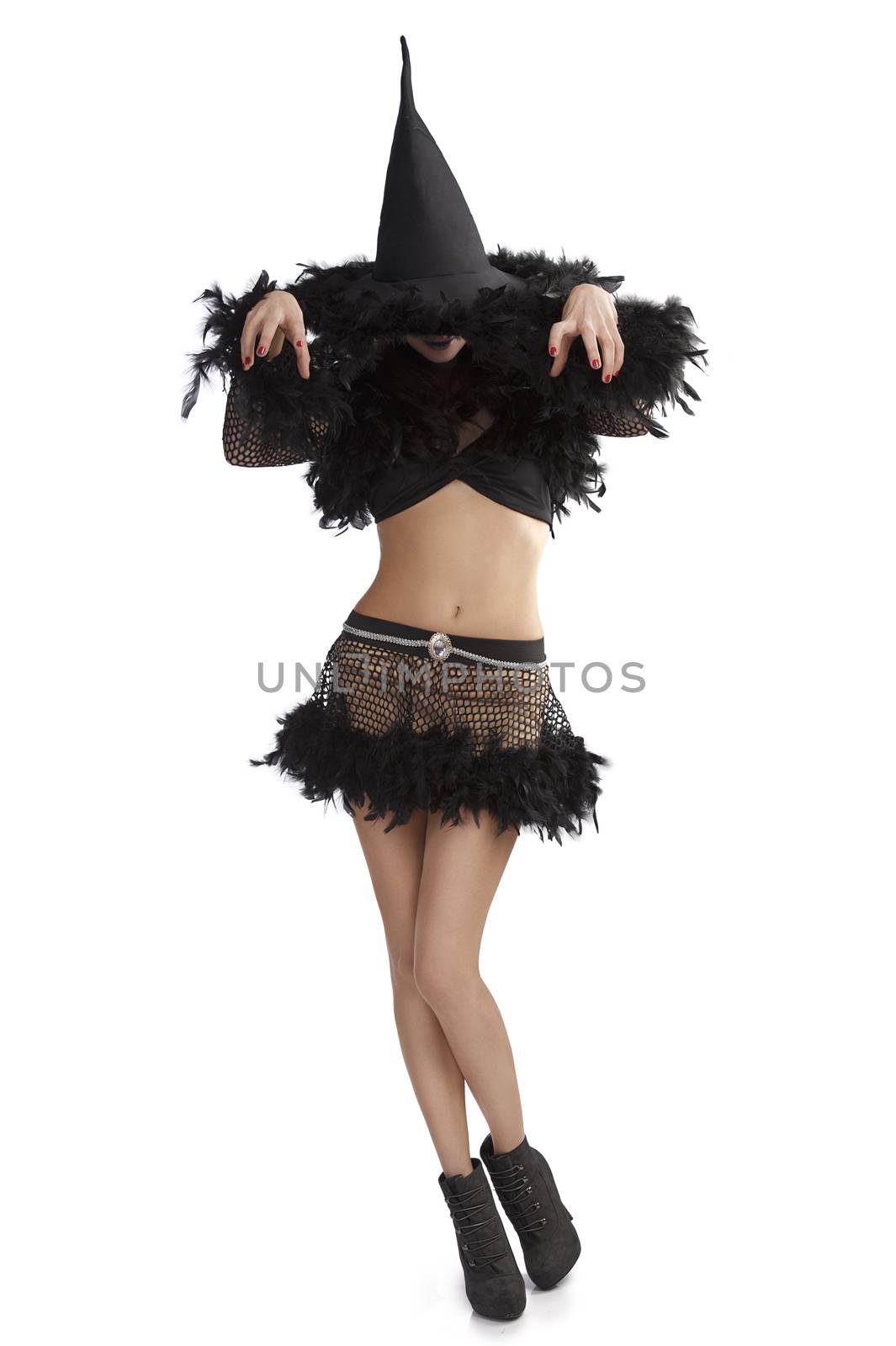 very pretty young brunette in black witch dress with hat and high heel ready for halloween in scary pose against white background