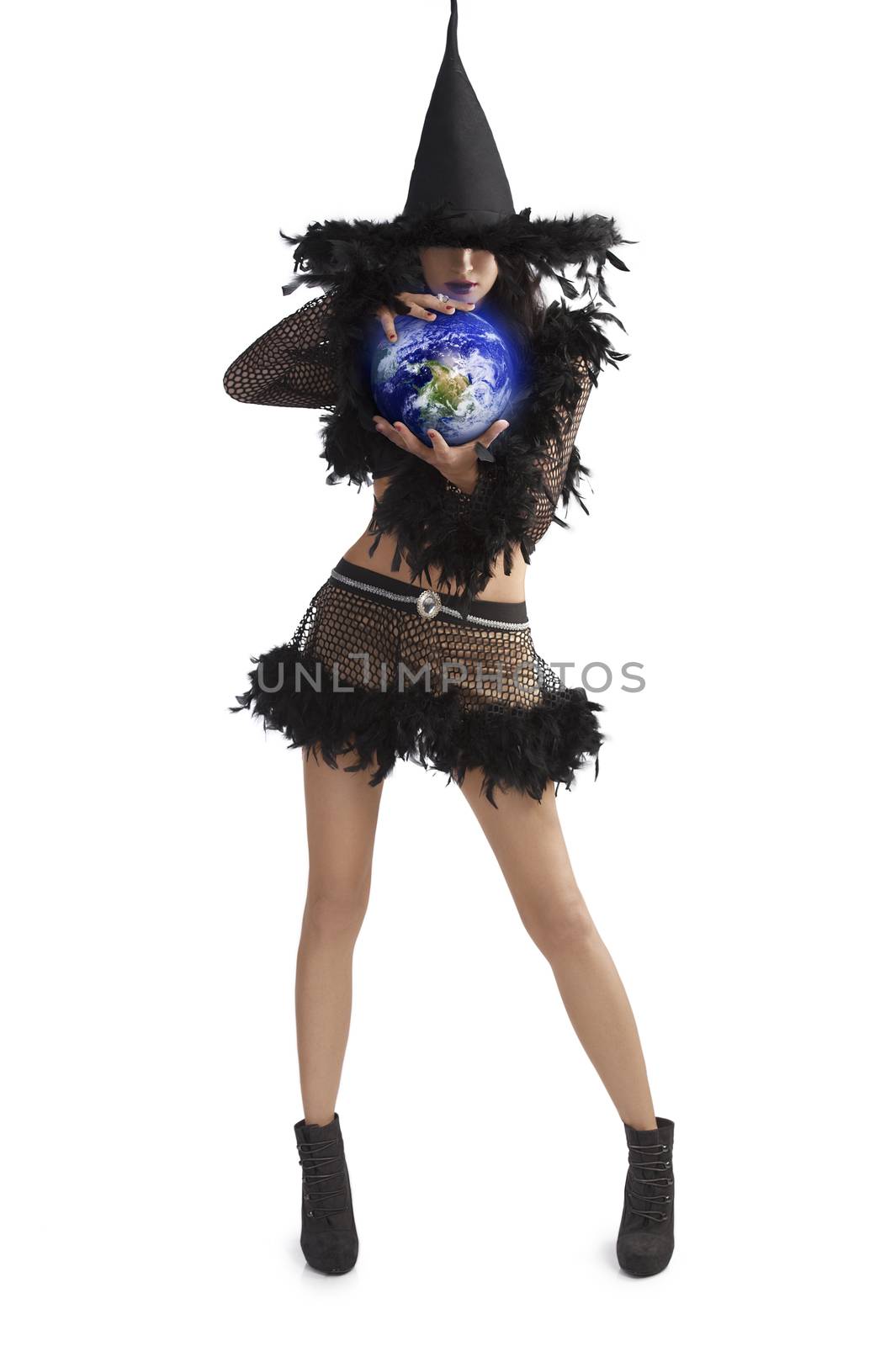 very pretty young brunette in black witch dress with hat and high heel ready for halloween holding world ball against white background