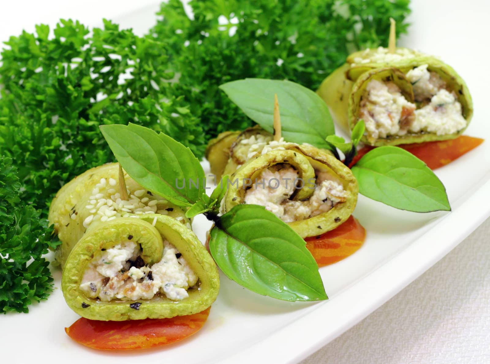 Zucchini roll with cottage cheese and herbs