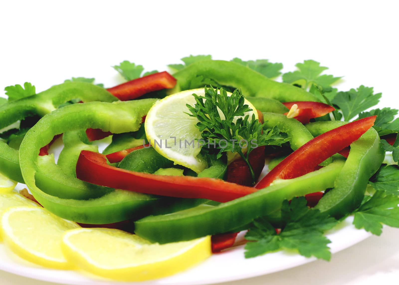 Fresh fruits and vegetables assorted presented white plate 