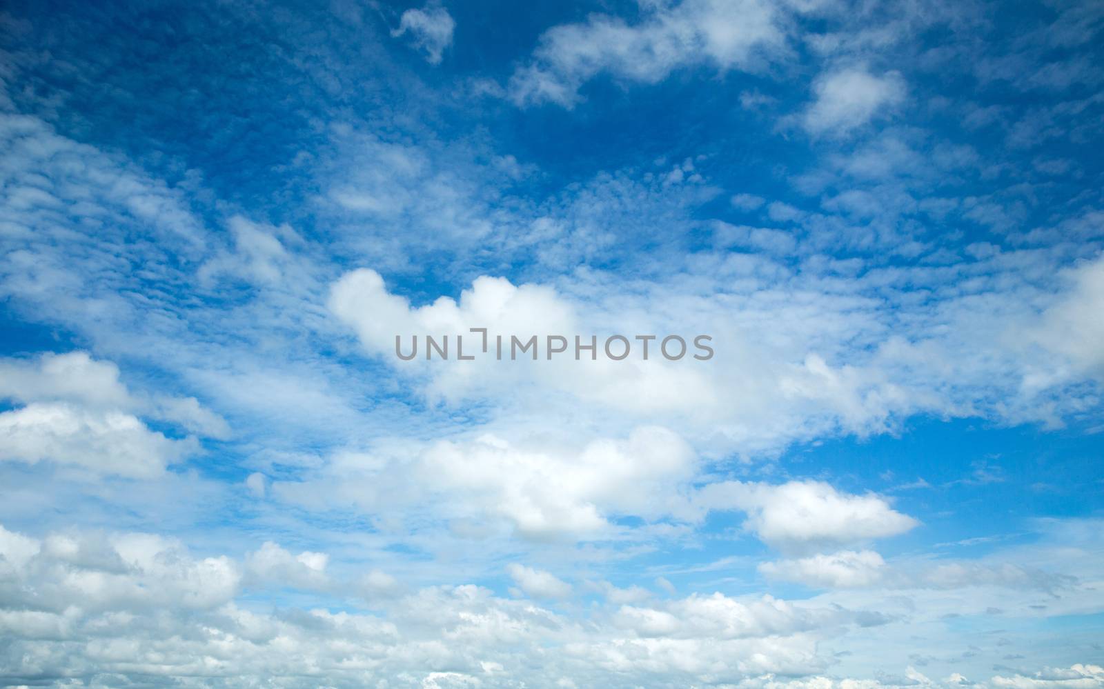 blue sky background with tiny clouds