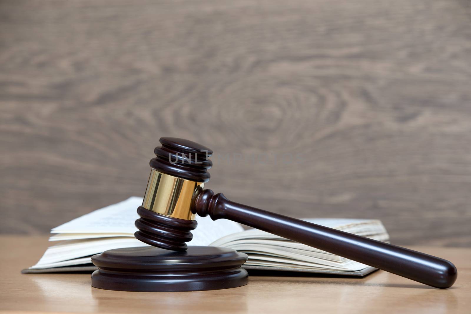 wooden gavel and books on wooden table