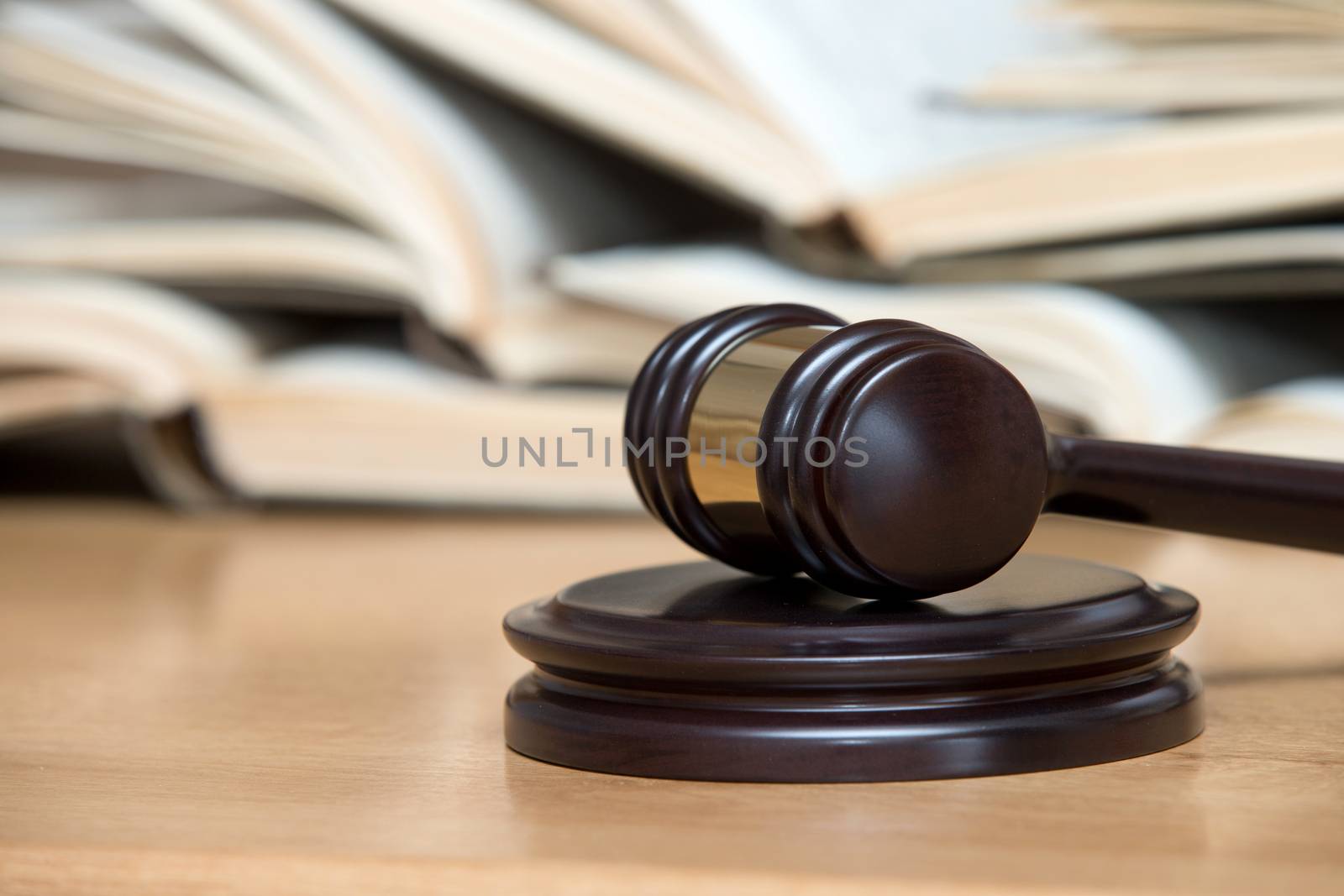 wooden gavel and books on wooden table