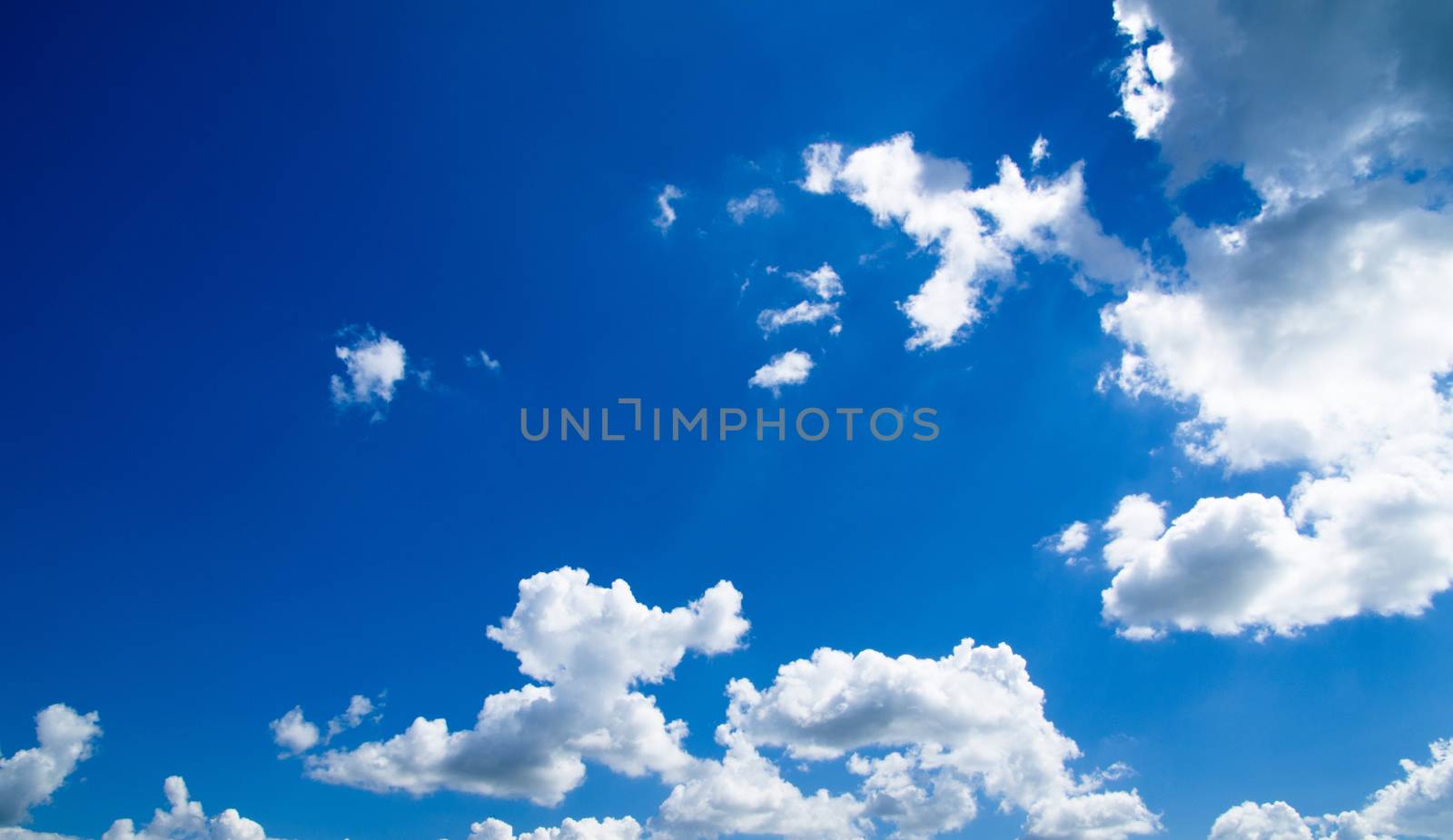 Blue sky background with a tiny clouds