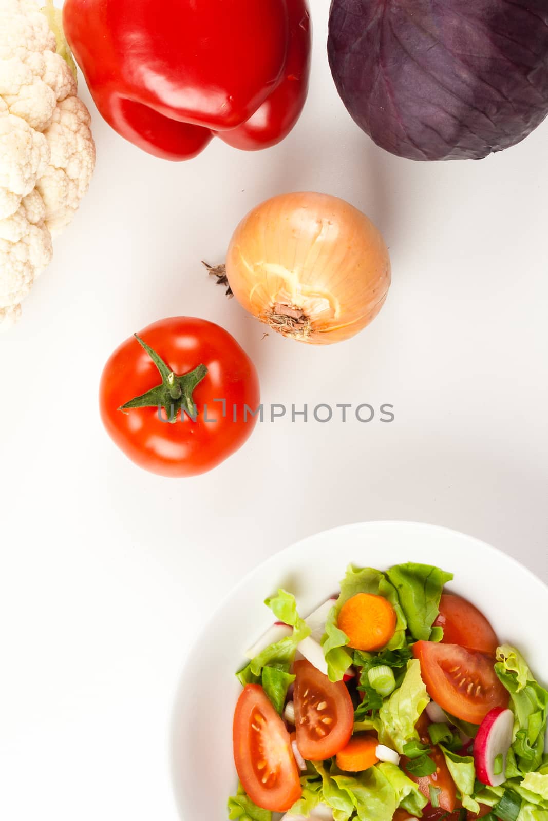 vegetable salad in a white bowl with different vegetables