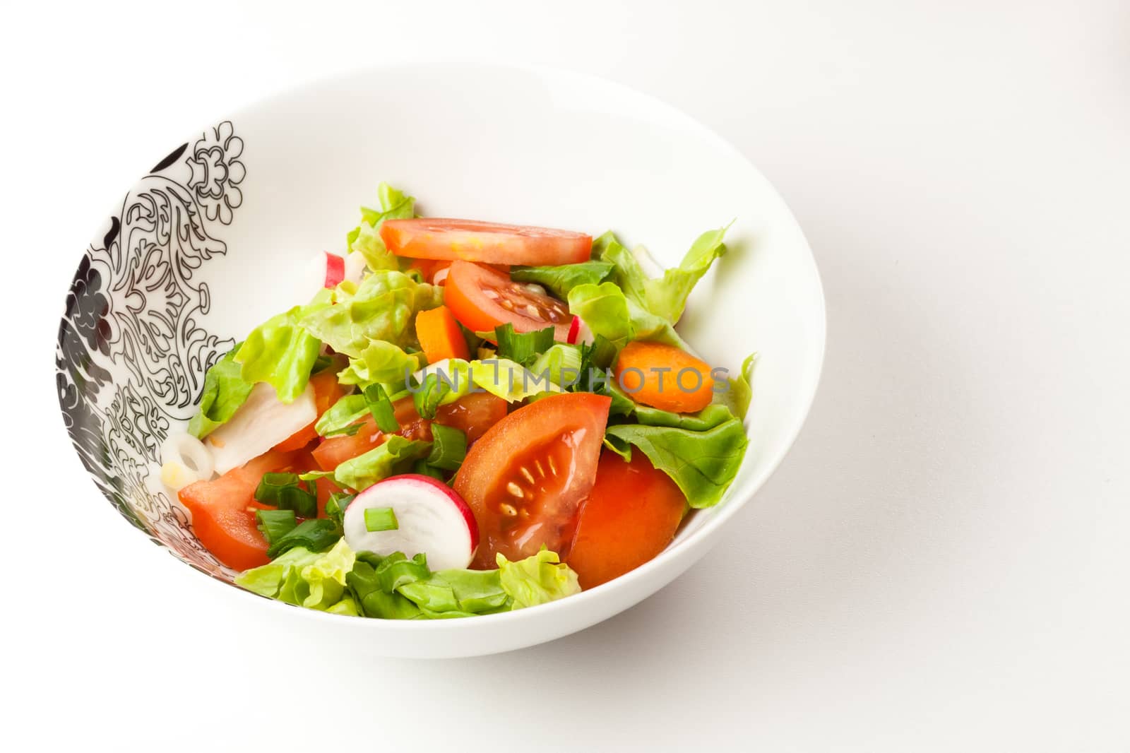 vegetable salad in a stylish black and white dish