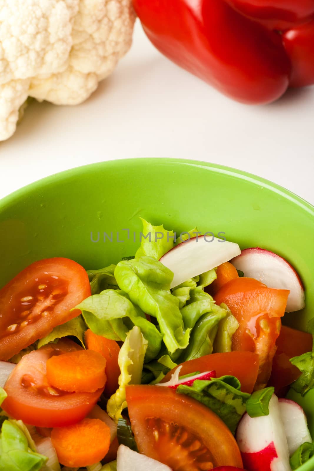 vegetable salad in a green bowl with different vegetables