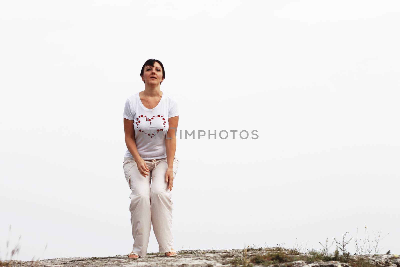 Adult smiling woman ready to jump outdoor