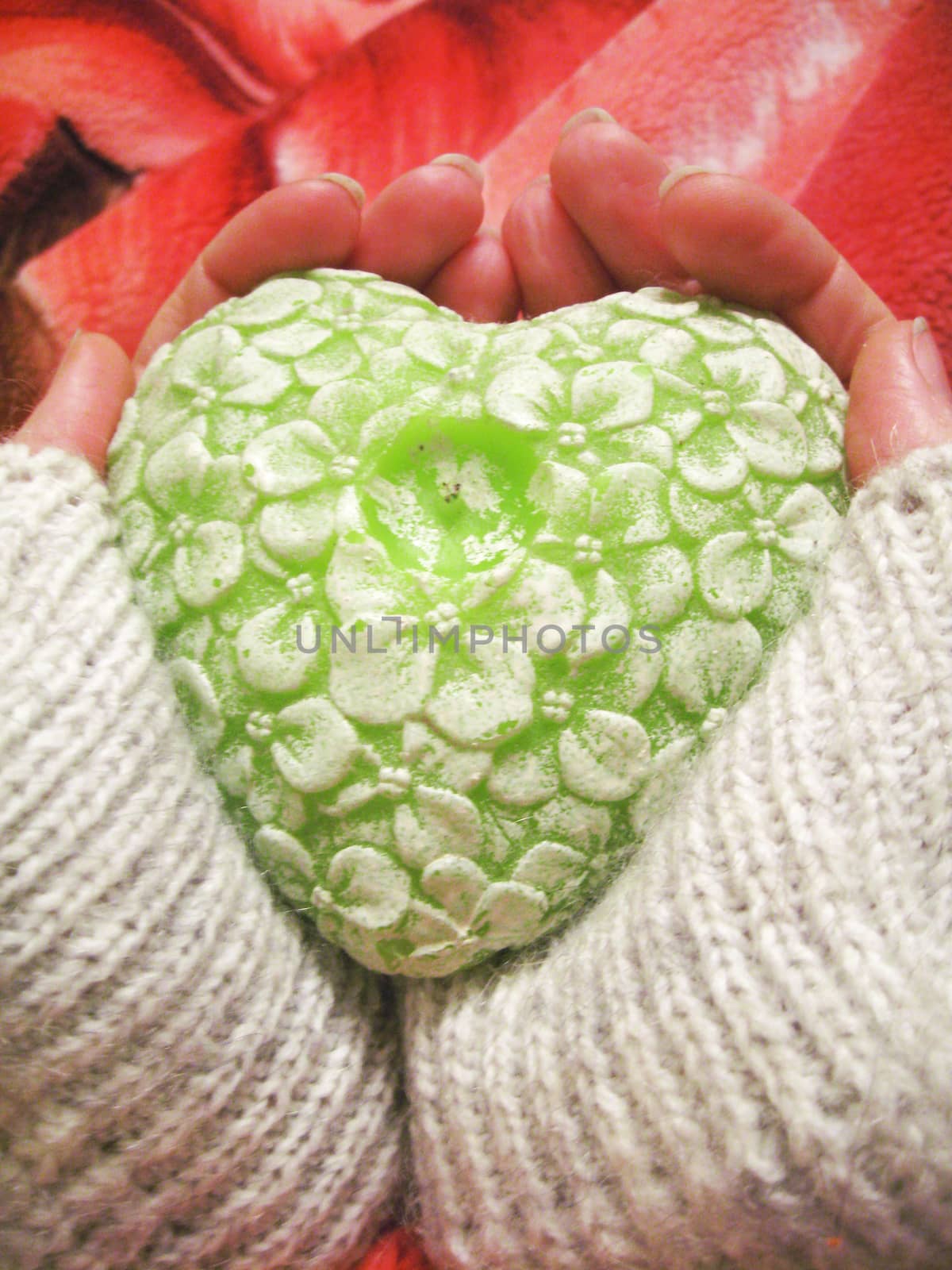 Valentine heart and heart shape candle in woman hands
