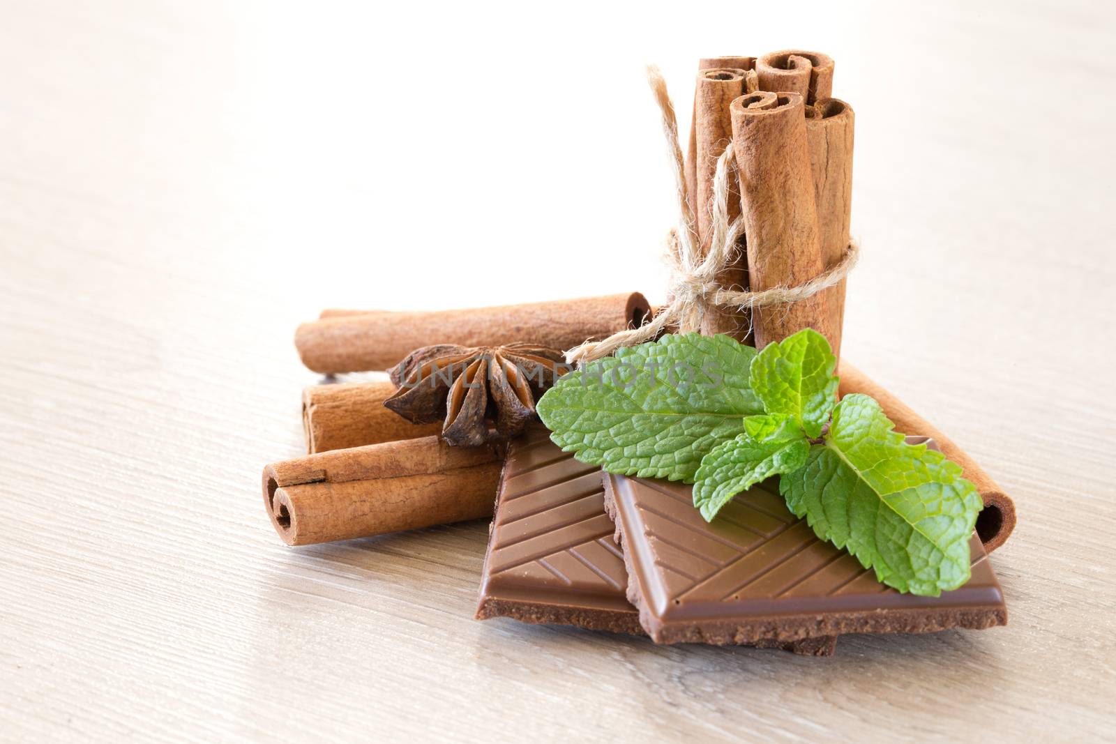 Mint with cinnamon on wood background