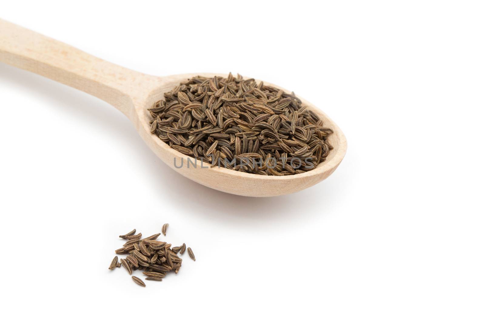 cumin seeds in wooden spoon