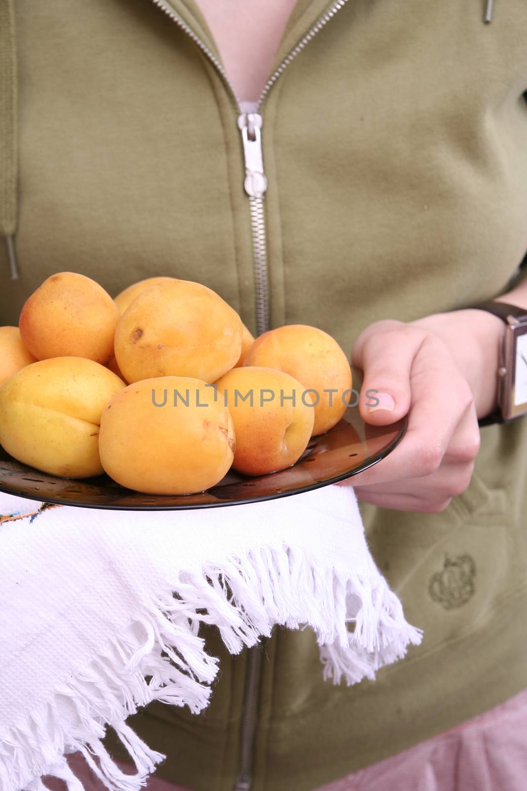 Plate with juicy yellow apricots.