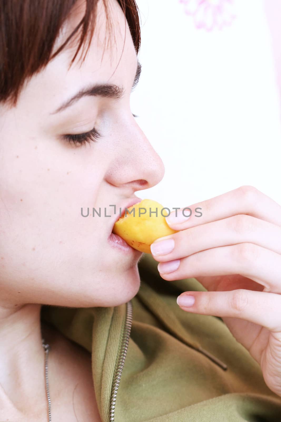 Women eating fresh yellow apricot .