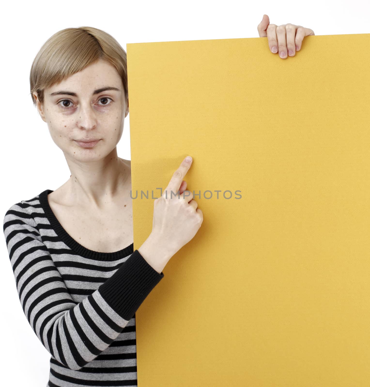 Young blonde woman holding a blank piece of paper.