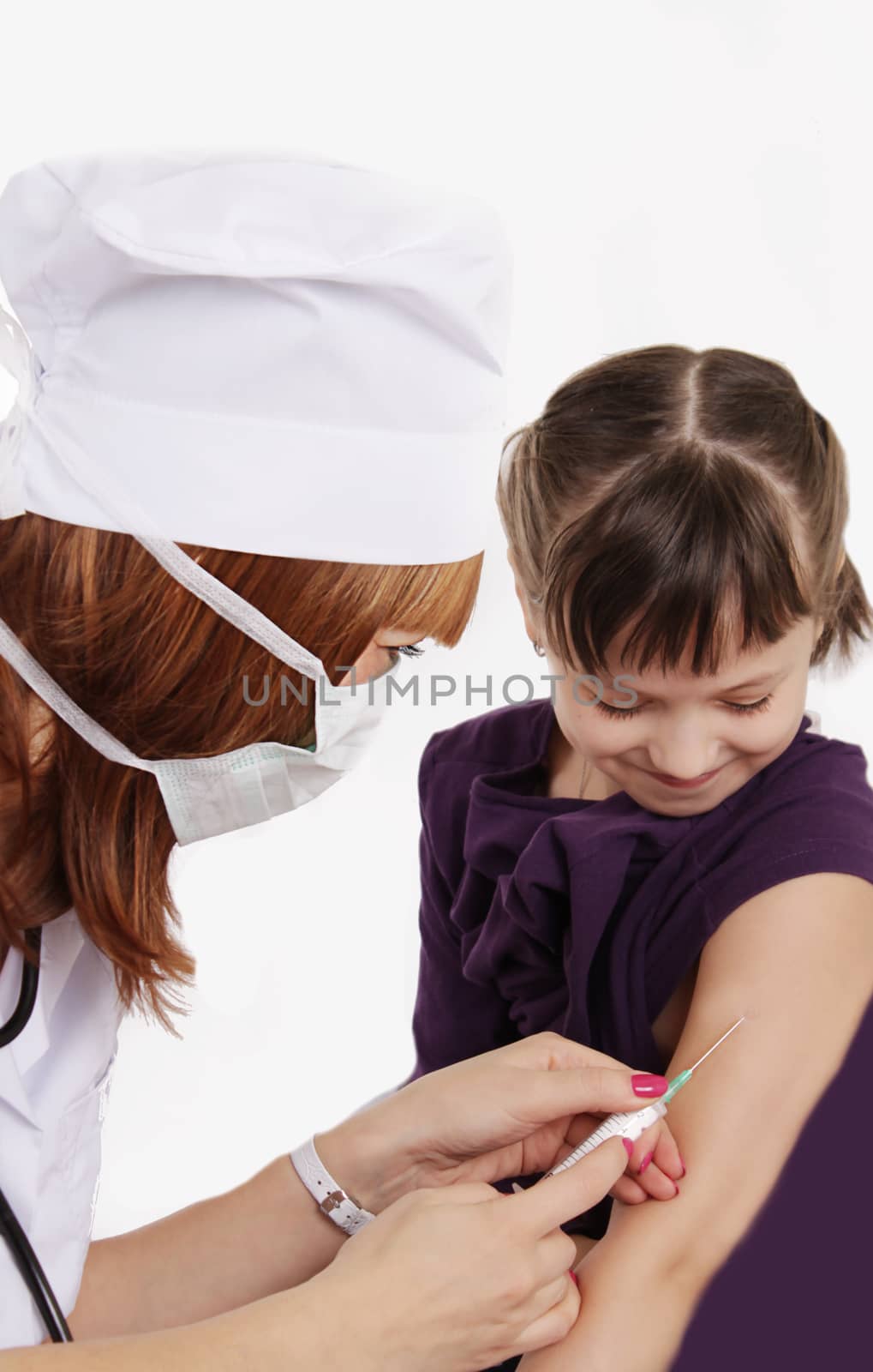 Woman doctor vaccinating girl in hand over white
