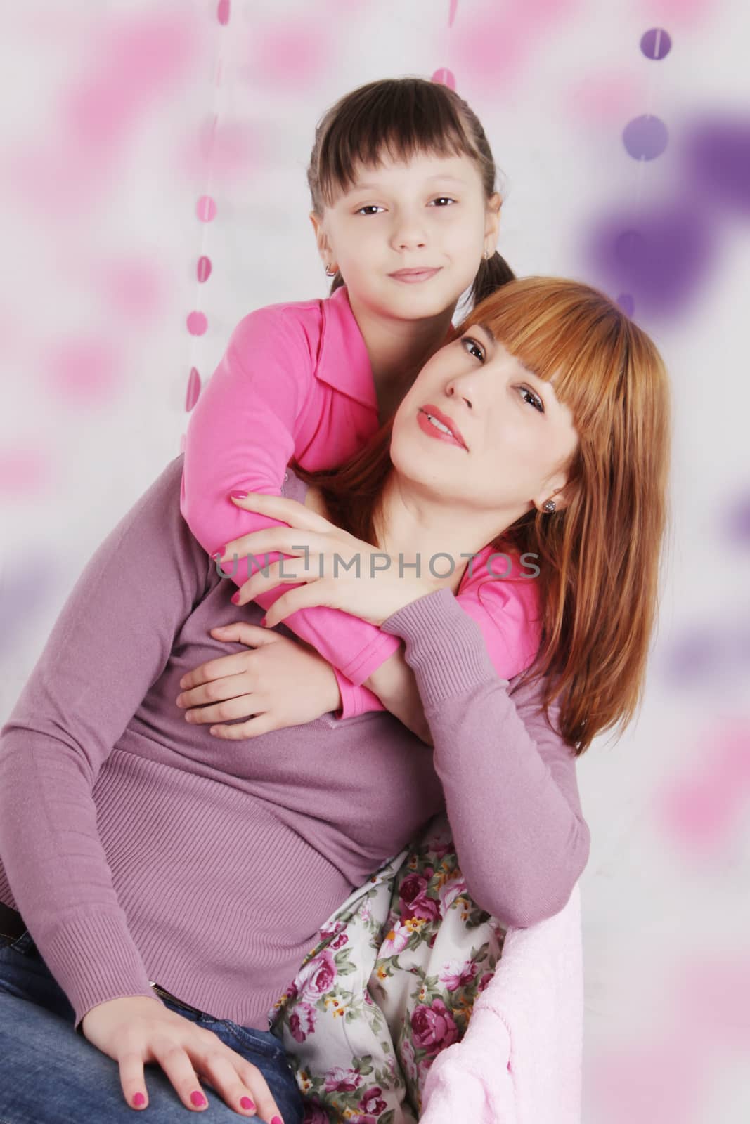 Mother and daughter hugging, pink decoration