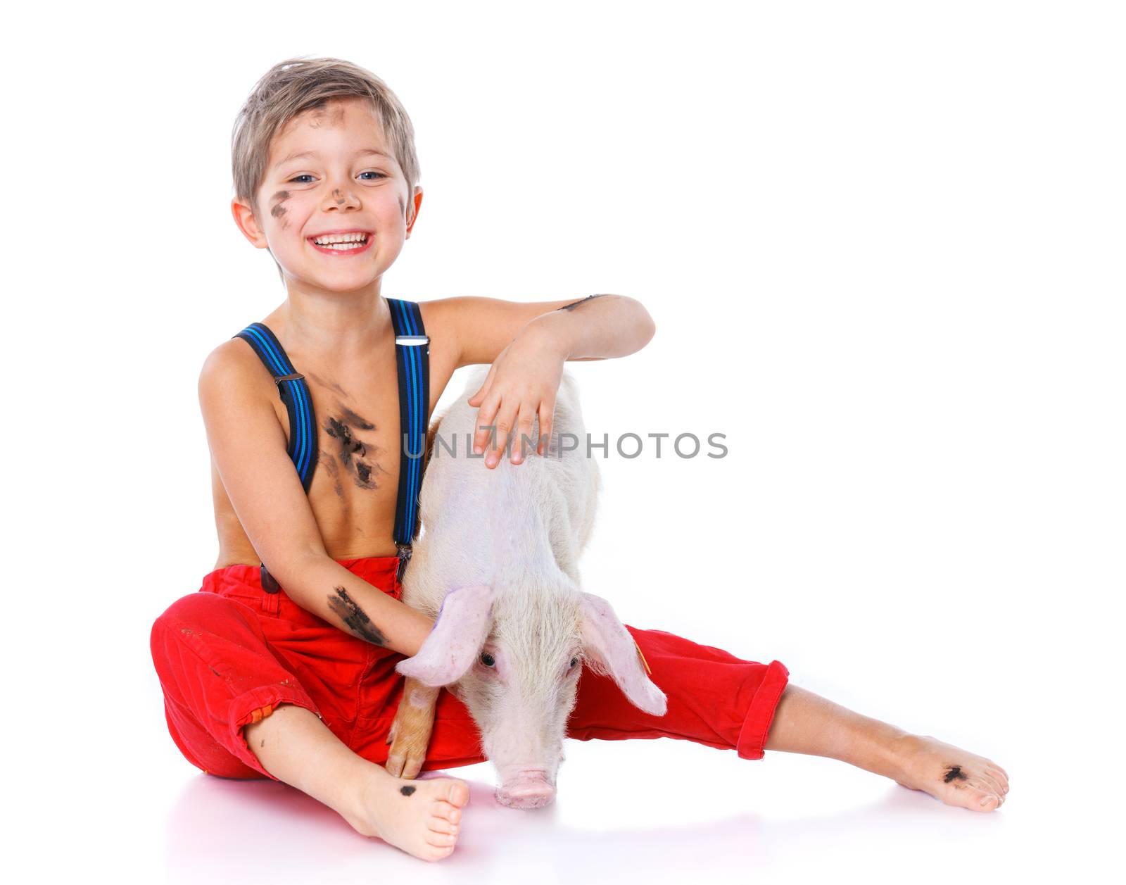 Little farmer. Cute boy with pig. Isolated on white background.