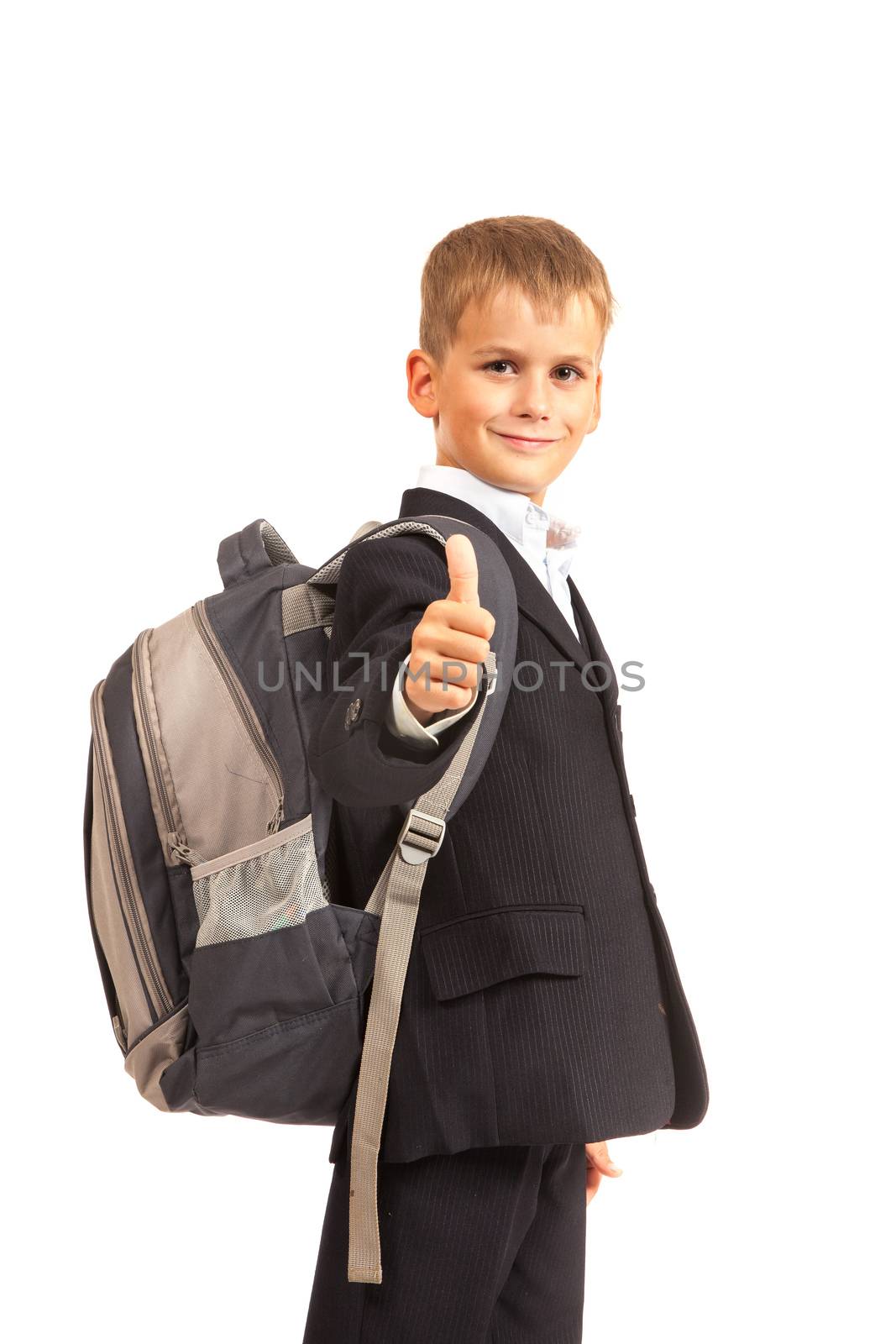 Schoolboy sitting on books isolated on a white background