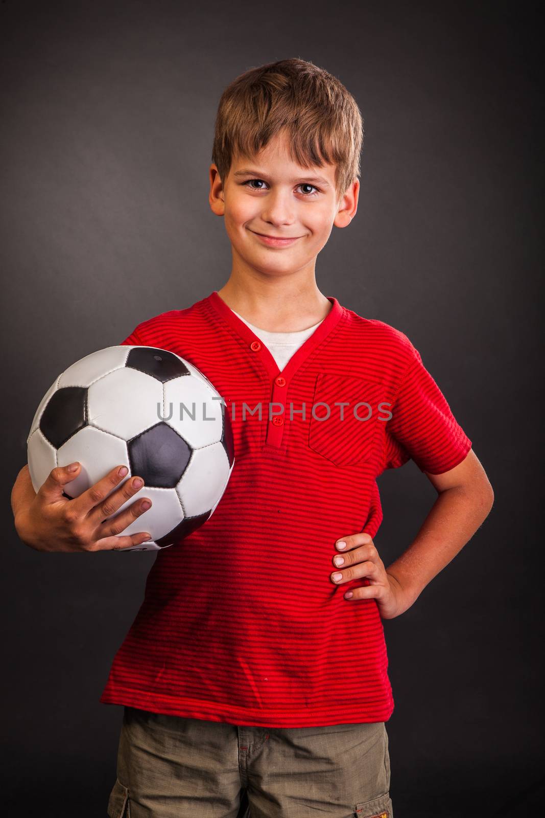Cute boy is holding a football ball. Soccer ball by bloodua