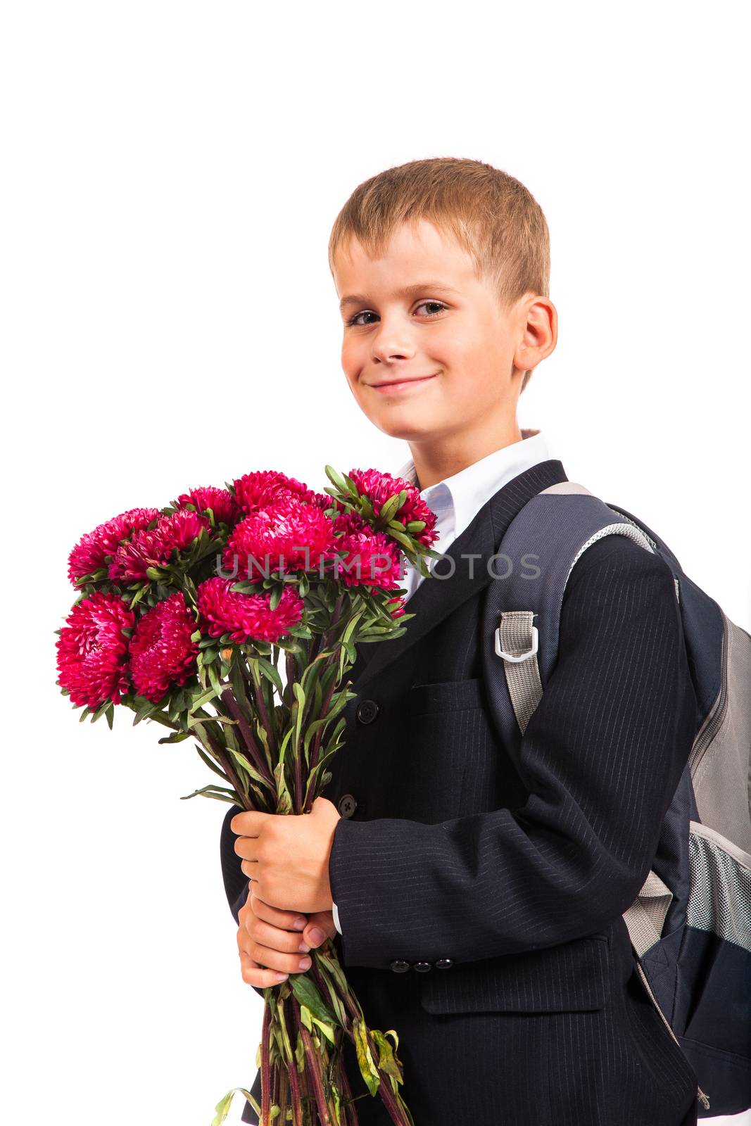 Handsome little schoolboy is holding flowers isolated on white background. Back to school