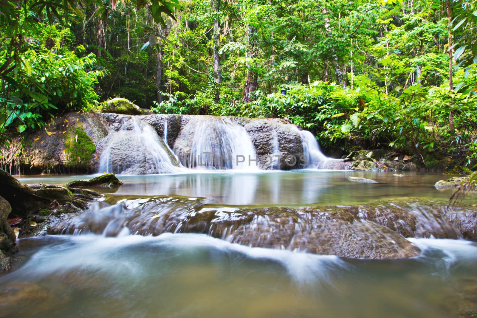 Waterfall in forest by wyoosumran