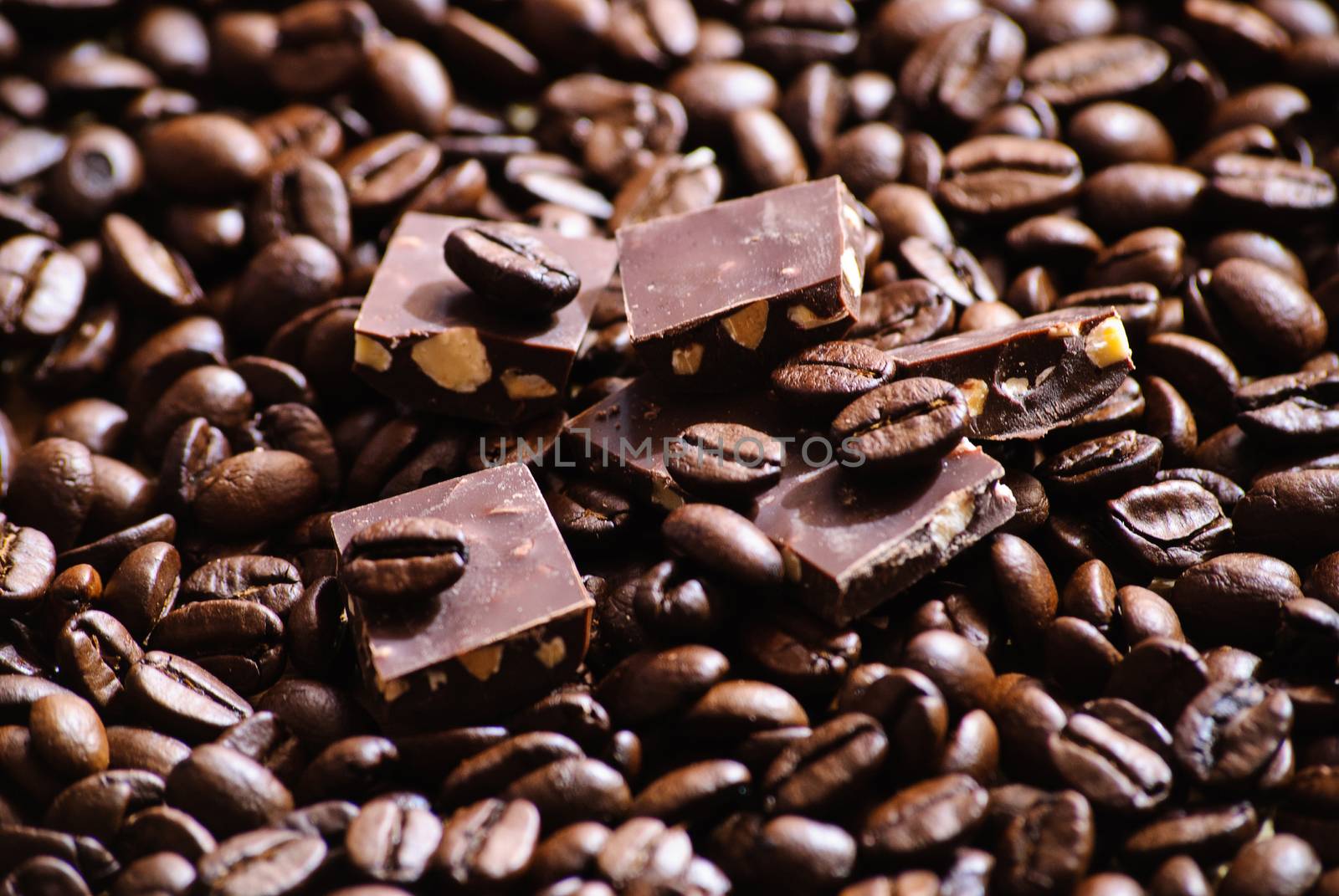 Close-up of roasted coffee beans and pieces of chocolate